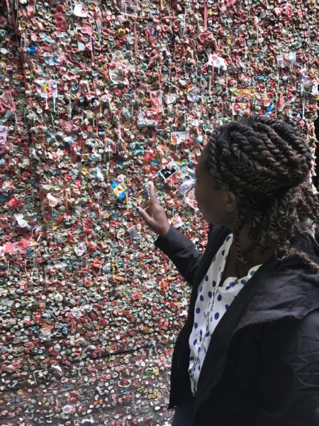 Young blogger placing gum on Seattle famous gum wall